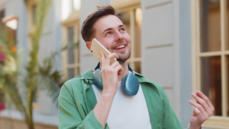 man tourist having remote conversation communicate speaking by smartphone with friend good news
