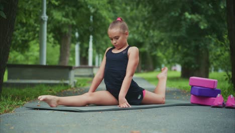 a young girl demonstrates incredible flexibility and strength in a beautiful outdoor yoga practice, showcasing skillful poses and calm concentration