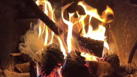 slowmotion of a nice wood fire inside a iron stove