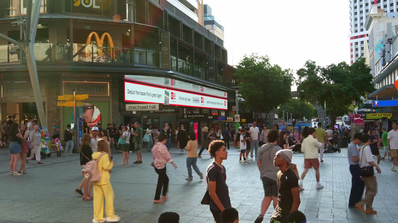 Bustling urban lifestyle, street scene of downtown Brisbane city on the weekend, shoppers shopping at Queen street mall, people strolling at the outdoor pedestrian shopping precinct, time-lapse shot.