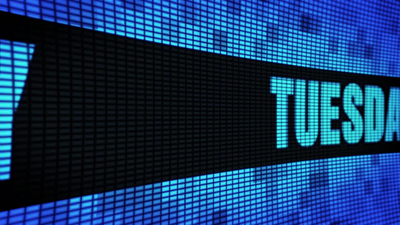 Tuesday displayed on a digital LED screen