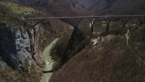 tara bridge in montenegro, over which cars pass and the tara river flows under them