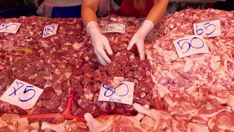 hands organizing various cuts of meat