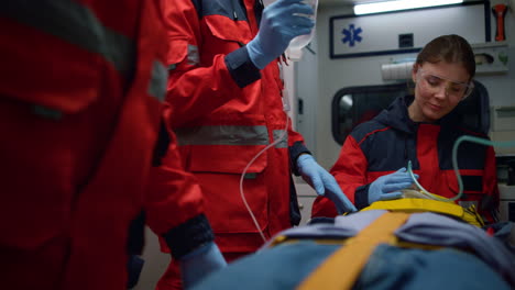 emergency doctors providing first aid help to patient in emergency car