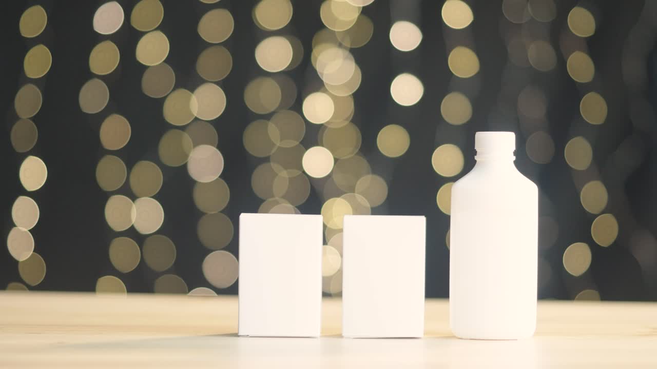 Two white squares and bottles on blurry background