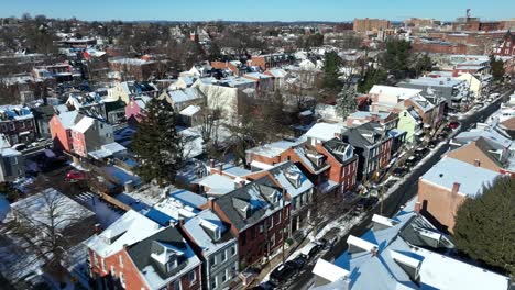 Drone-flight-over-beautiful-row-of-houses-in-winter-snow