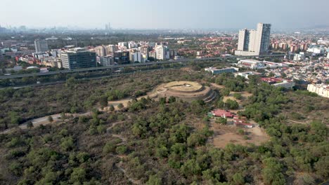 tomada orbital del núcleo de la pirámide azteca de cuicuilco en la ciudad de méxico y un edificio residencial cerca