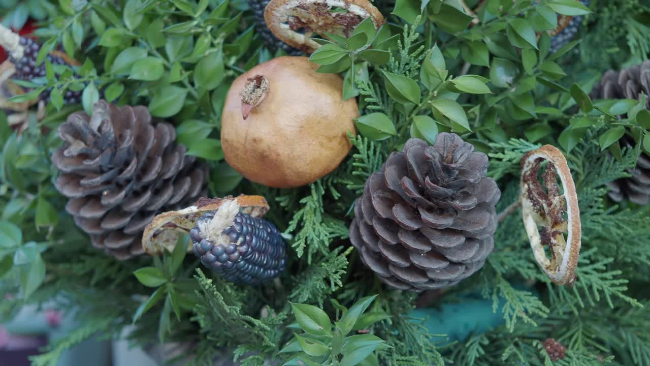Decorative Arrangement with Pine Cones, Pomegranate, and Dried Orange Slices