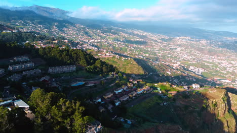 residential houses located on the picturesque mountain. beautiful town on the slopes of rock on the madeira islands, portugal. aerial view.