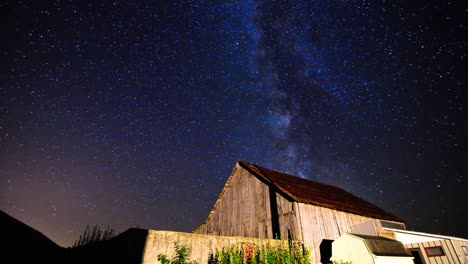 milky way time lapse sliding over old barn on farm