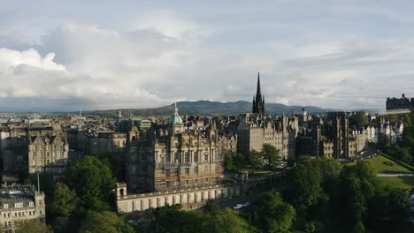 aerial view of edinburgh's museum on the mound with sunlight casting warm light on the downtown buildings