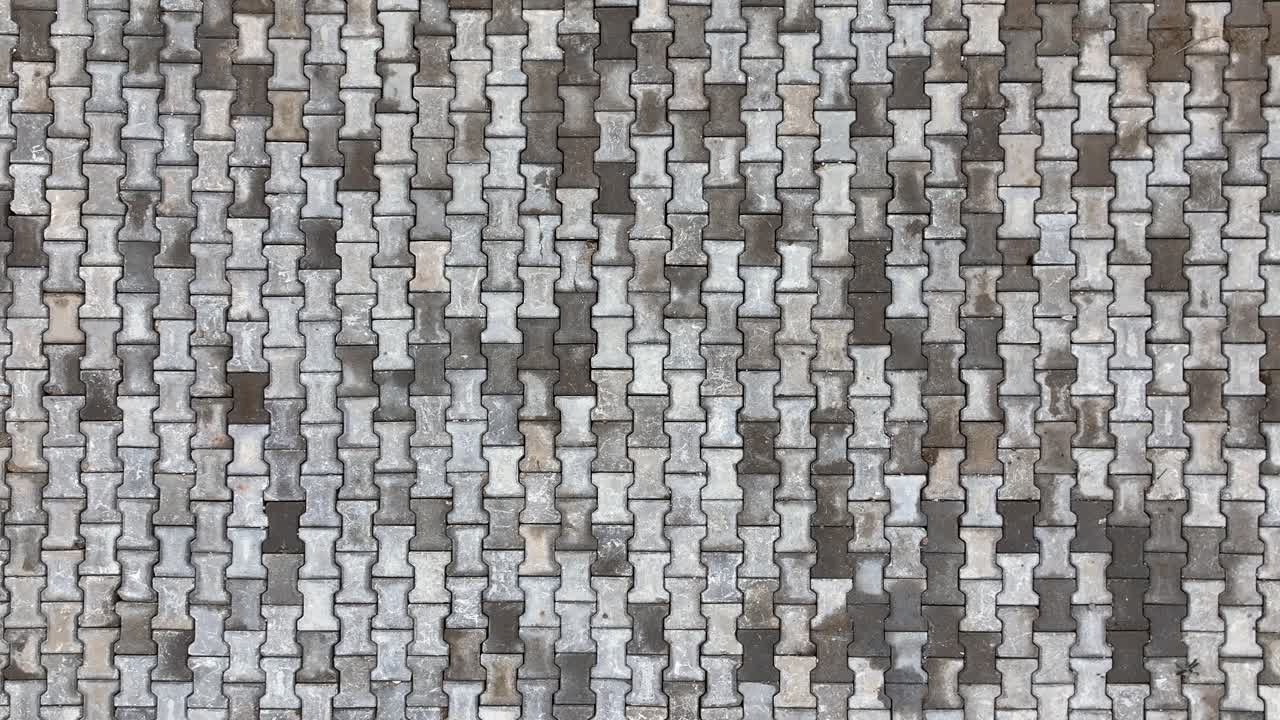 Top view of interlocking paving stone texture. Outdoor concrete slab pavement high quality drone image