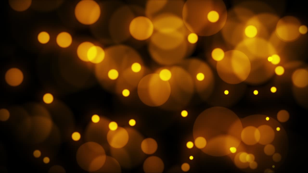 Beautiful golden bokeh blur particles abstract light on black background.