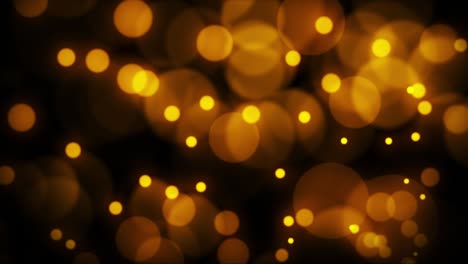 hermosas partículas borrosas de bokeh dorado luz abstracta sobre un fondo negro.