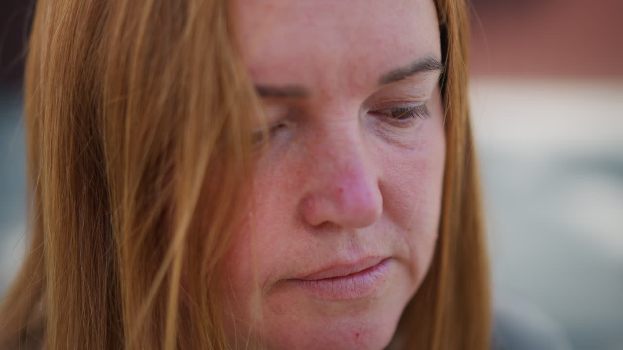 Extreme close up of crying housewife wiping tears with napkin, emotional face showing sadness and exhaustion, hair gently falling across face, tender moment of sorrow