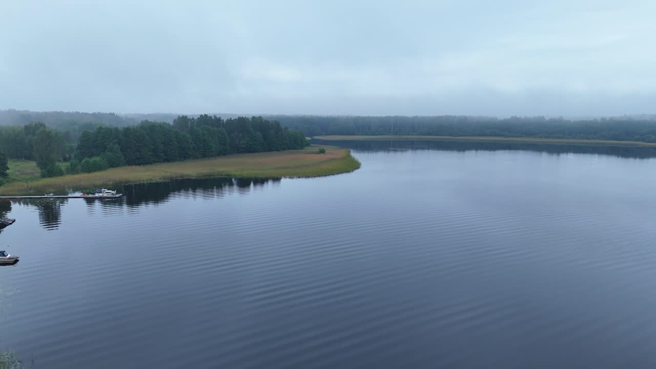 Lake Usma With Calm Waters In The Early Morning In Latvia. - aerial shot