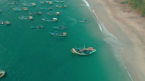 indonesia traditional fishing boats docked in shores after fishing an aerial view, papuma beach jember