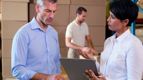 warehouse manager talking with colleague