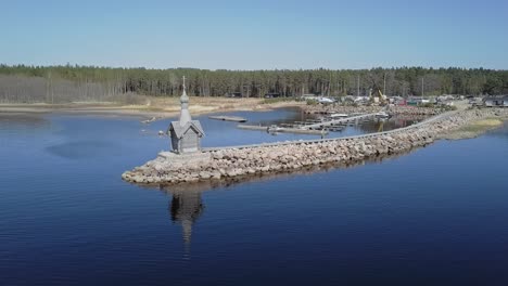 rocky shore with a small orthodox chapel aerial view