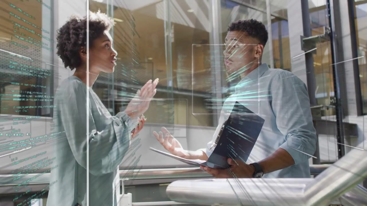 Man holding laptop starting UI, woman pointing and gesturing, colleagues analyzing tech code