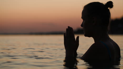 woman in water praying or meditating