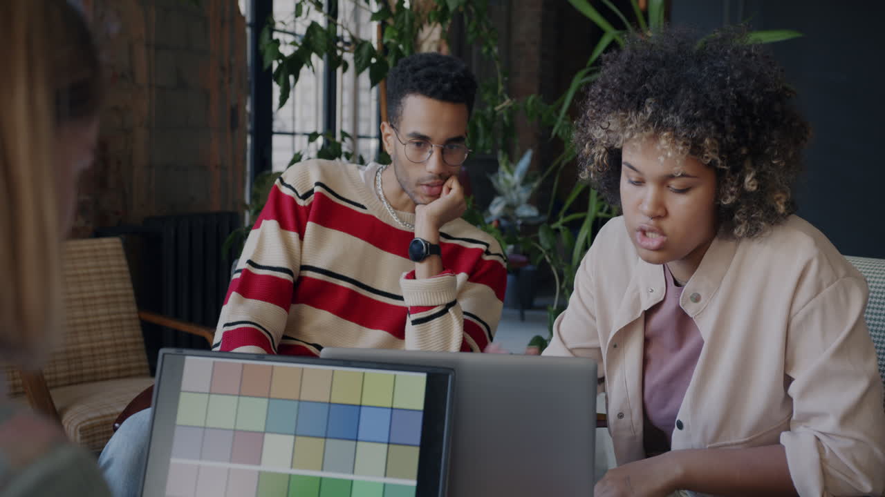Team Discussing Color Palette in a Cafe