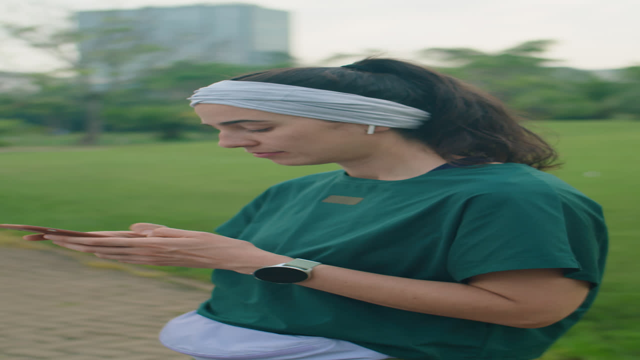 Woman Using Smartphone before Outdoor Morning Workout