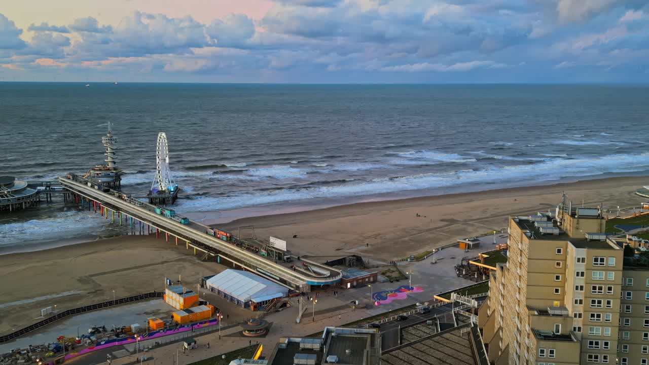 The Hague, Netherlands - November 21, 2024: Aerial drone view of the Scheveningen Pier and Ferris Wheel at the Dutch North Sea Coast