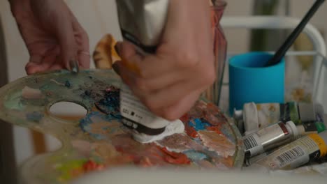 artist working with paint and palette