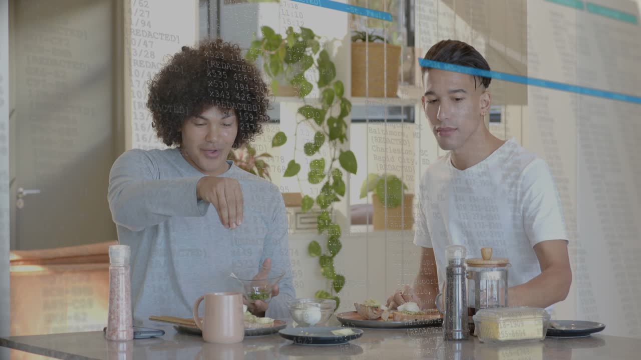 Two men at bar making food, laughing, left spooning herbs, right sipping, blue lines hiding faces