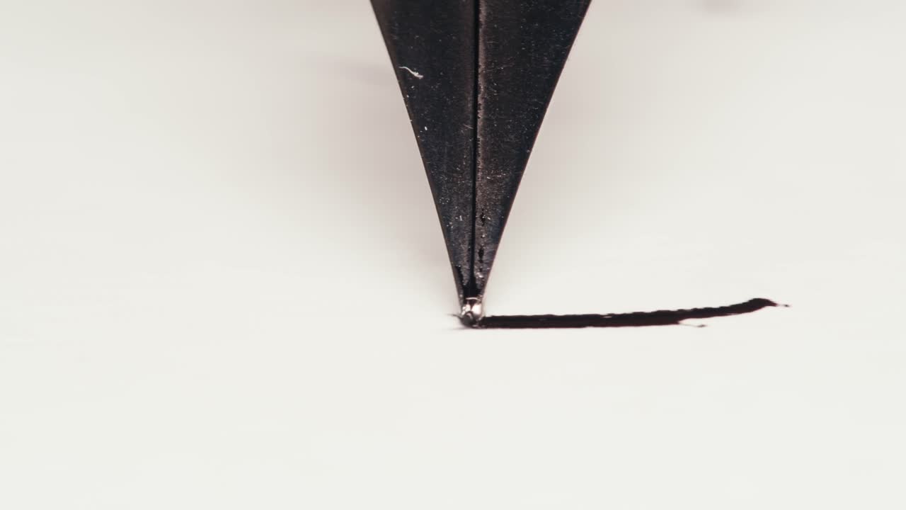 Close-Up of Fountain Pen Nib Writing with Black Ink