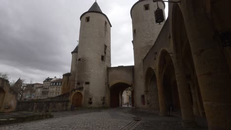 Modern-cars-pass-outside-the-German's-Gate,-a-castle-that-dates-back-over-seven-centuries