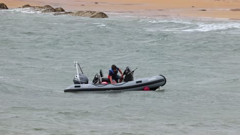 two people rescuing a buoy in the water