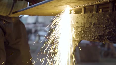 bright spark shower under the steel plate while cutting with fire torch cutter