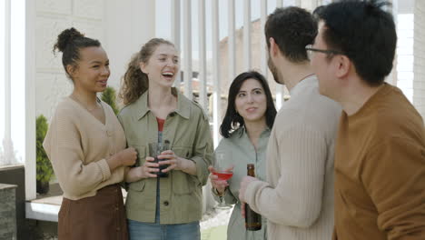 a nice  group of friends chatting happily on a terrace of a house 1