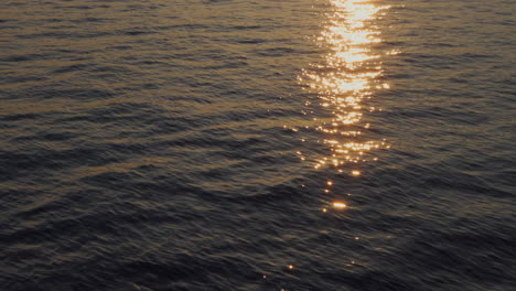 the sun is setting and is reflected in the water