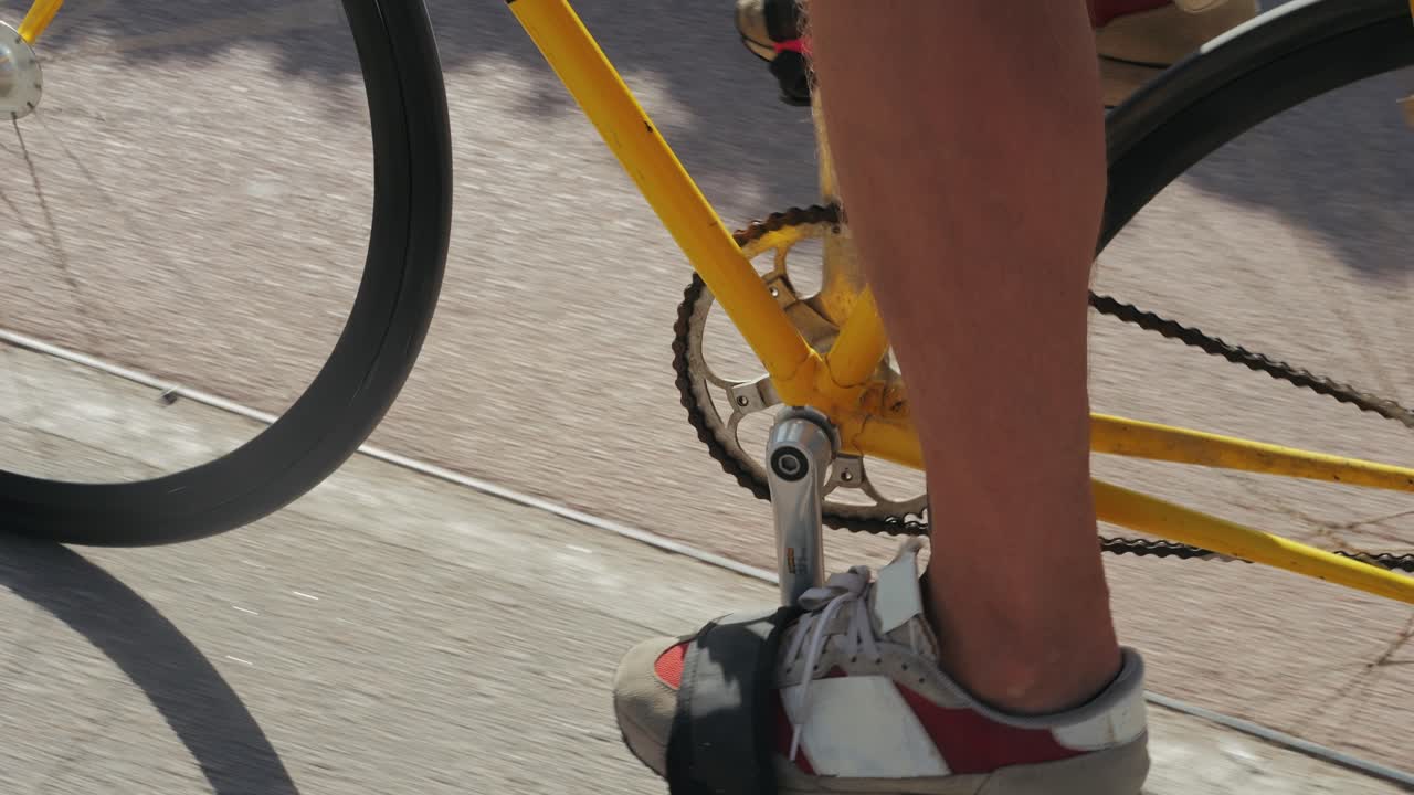 Person Riding a Yellow Fixie Bicycle