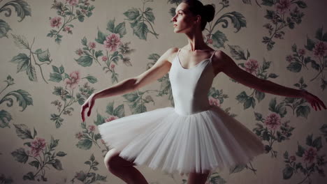 ballerina in white tutu against floral wallpaper