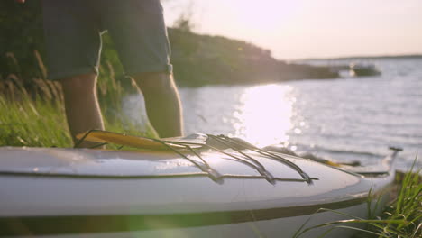 kayak paddle placement. sunset light by the beach