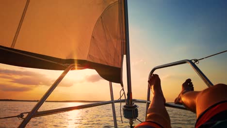 Close-Up-Shot-Relaxed-Traveler-Man-Legs-on-Motorboat-on-Beautiful-Island-and-Mountain-Carefree-Concept