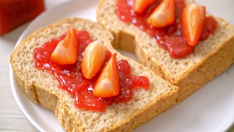 homemade whole wheat bread with strawberry jam and fresh strawberry