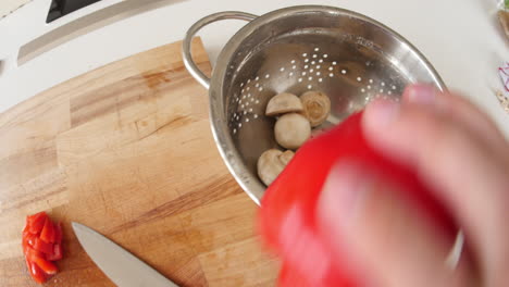 Point-of-view-of-man-chopping-tomato-and-red-pepper