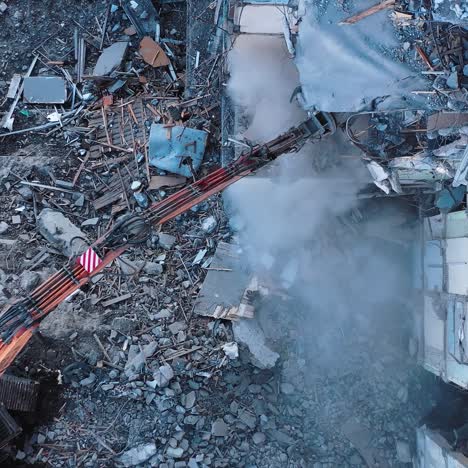 demolution destruction an old house building. destroying old house with bulldozer mechanical arm