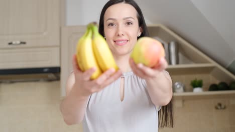 beautiful brunette woman holding an apple and a banana organic fruit beautiful brunette woman holding an apple and a banana organic fruit healthy food diet