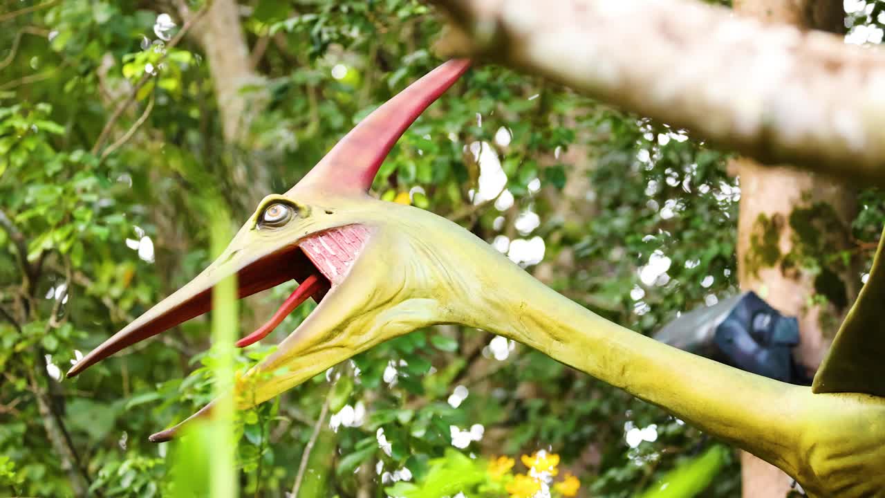 A vibrant Pteranodon sculpture in a lush, green environment with dynamic lighting and natural surroundings