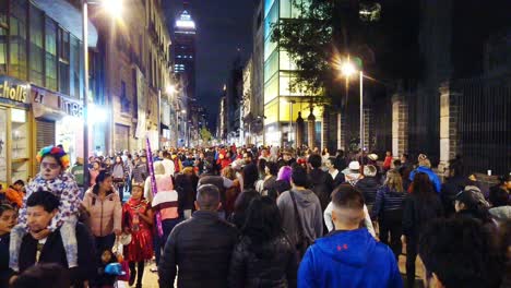 people walking in the street celebrating the day of the dead
