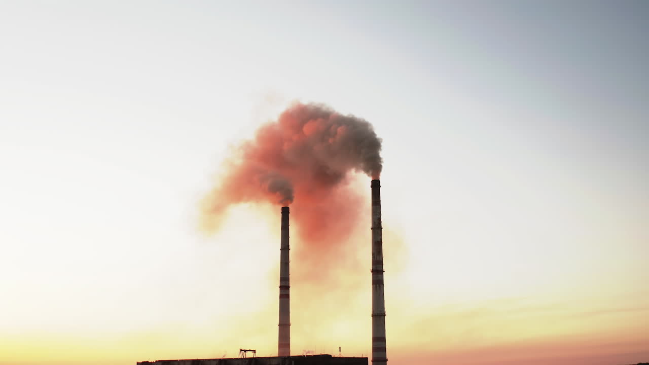 Drone view of pipes factory smoke. Aerial view of industrial zone with factory emission from factory pipes