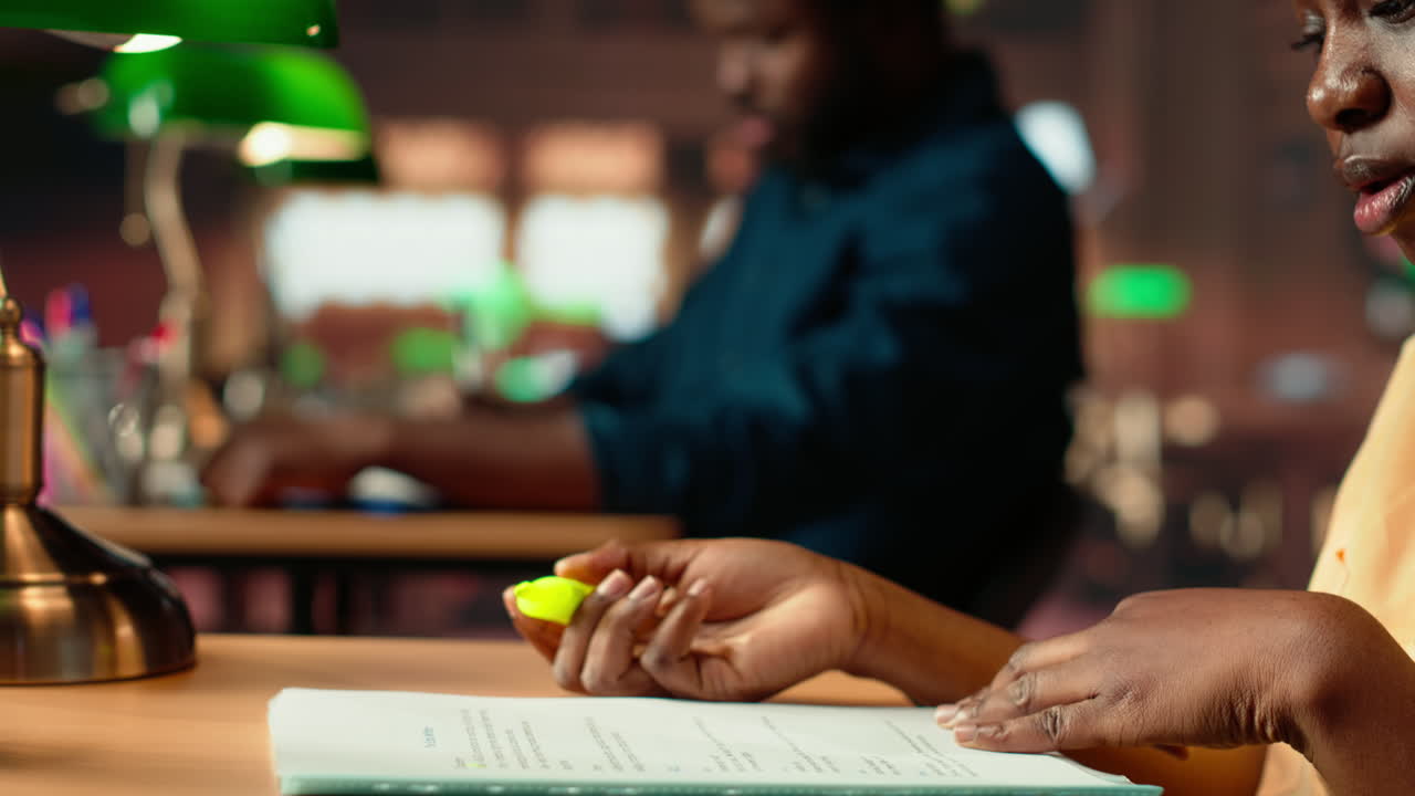 African american scholar highlighting the relevant information from class notes