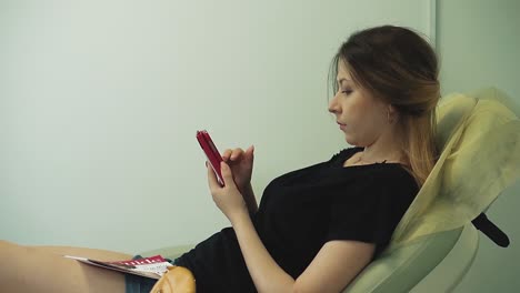 una chica bonita se sienta en una silla