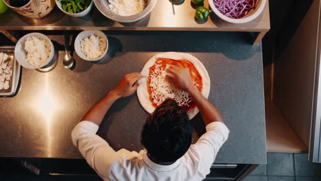 person adding cheese to pizza